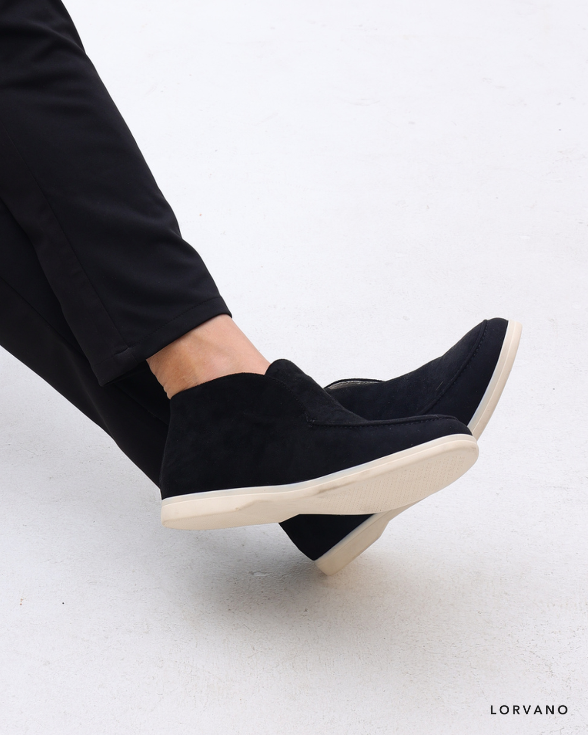 Lorvano High Suede Loafers in black suede worn with tailored trousers
