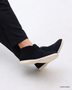 Lorvano High Suede Loafers in black suede worn with tailored trousers
