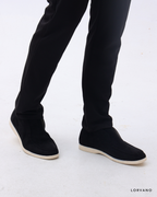 Lorvano High Suede Loafers in black suede worn, side view