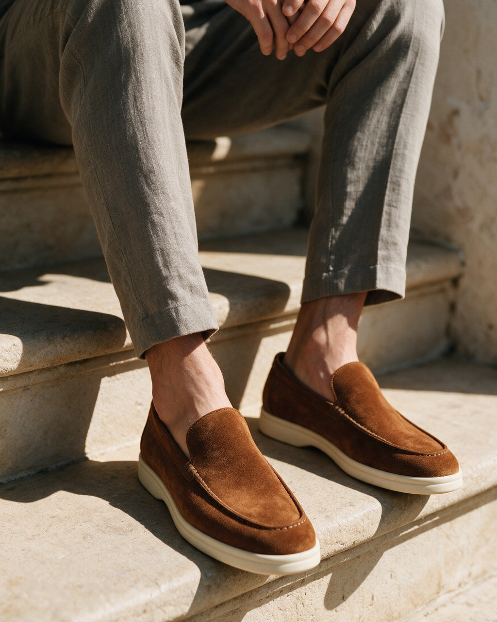 Lorvano Premium Suede Loafers in cognac suede worn on sunlit stone steps